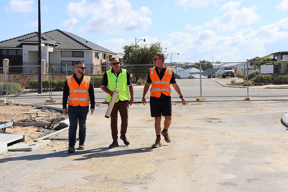 2 men walking through the Nautic Estate subdivision, with Project Manager Henry Dykstra