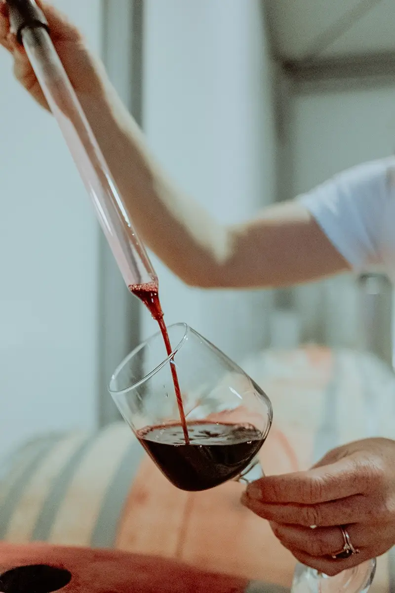 red wine coming out of a barrel