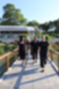 The Edith Valley team in black t-shirts walk towards the camera.