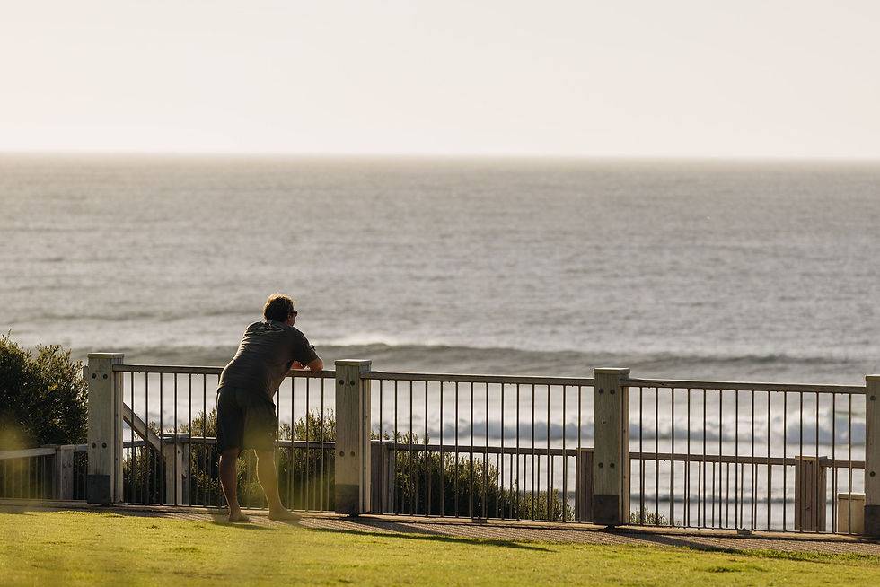 A man leans against railing at Yallingup beach