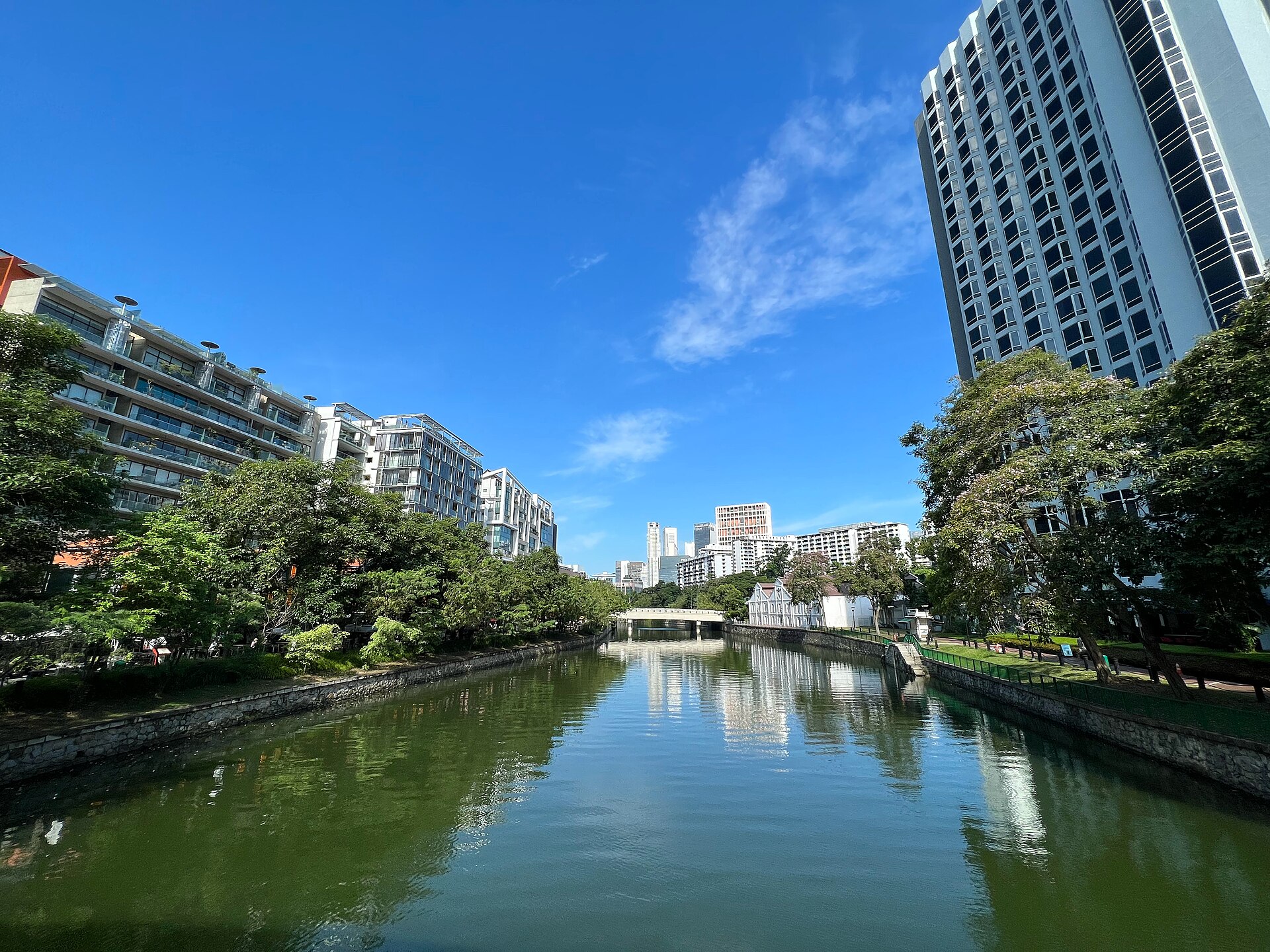 The Singapore River at Robertson Quay lined with trees and riverside buildings