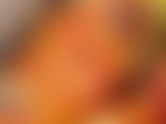 Bacon-wrapped stuffed zucchini with a golden, crispy texture. The setting is a dining table, evoking a warm, appetizing mood.