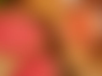 Top view of a jar filled with pink smoothie beside halved pink guavas on a wooden surface. Bright colors and fresh, tropical vibe.