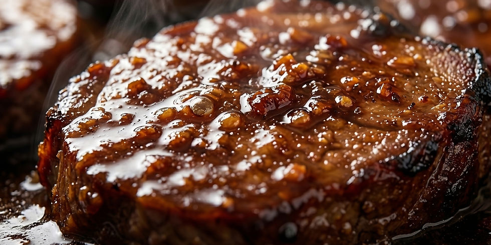 Close-up of a juicy steak glazed with a rich, glossy sauce, showing steam rising. The image captures a hearty, appetizing feel.
