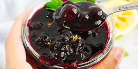 Homemade blueberry sauce with whole blueberries and glossy fruit syrup in a glass bowl