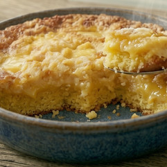 Lemon dump cake baked in a dish with creamy lemon filling and golden topping