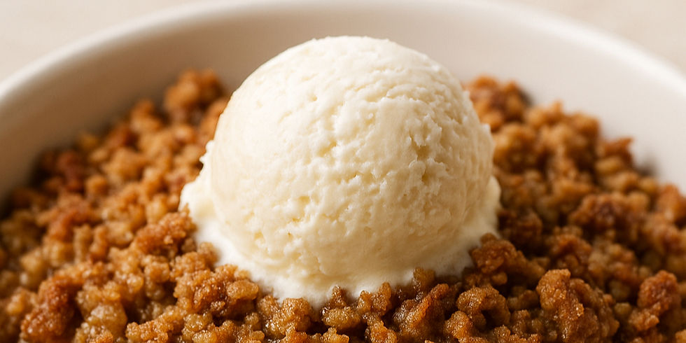 a white bowl of cooked apples crisp topped with a scooped of ice cream.