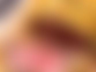 Close-up of sliced Beef Wellington on a wooden board. Golden pastry crust with herbs, and tender pink beef inside. Knife visible in the background.