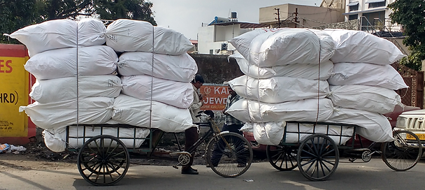 Men pulling heavy loads of carpet