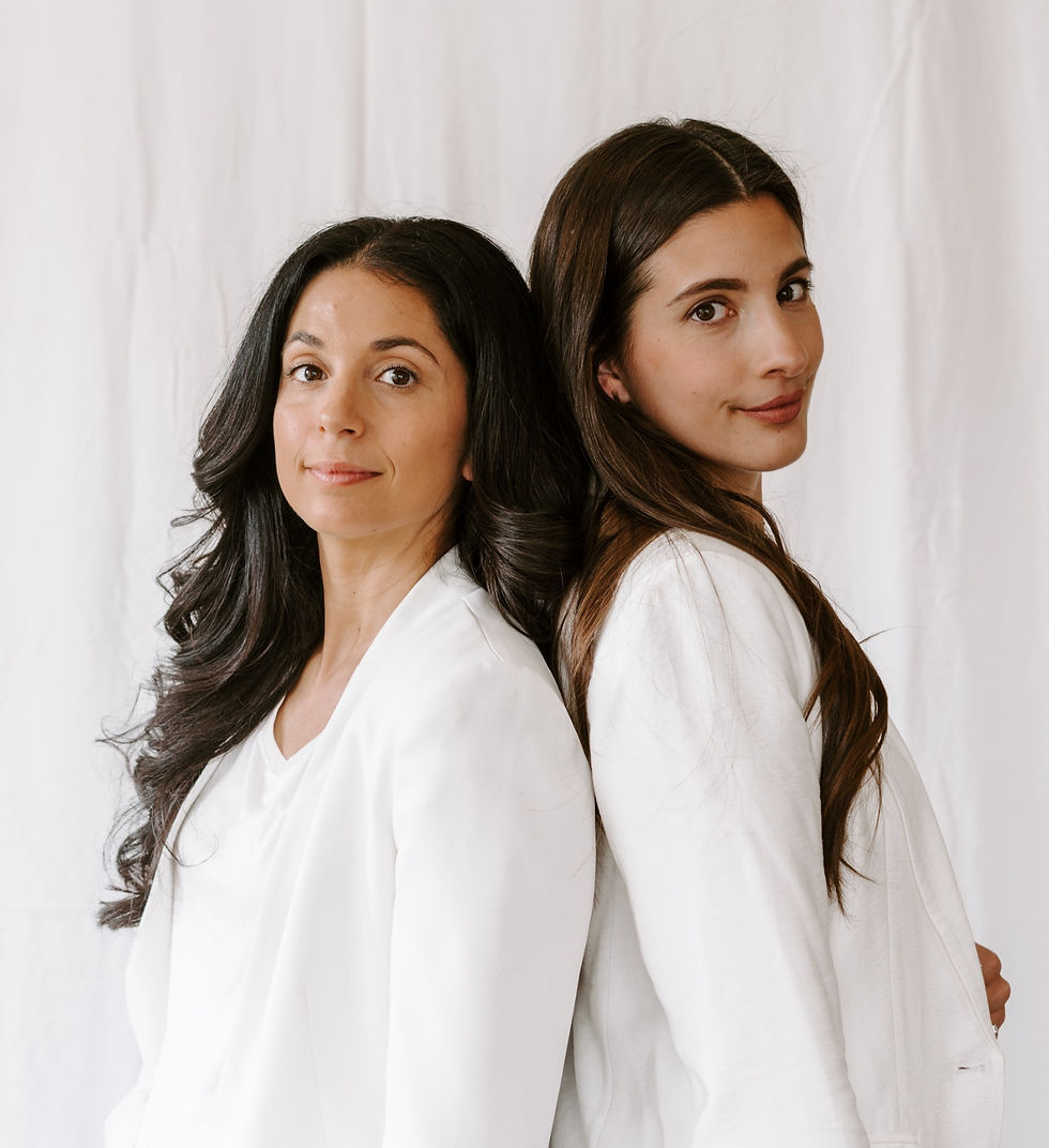 Two women standing back to back