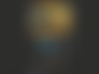 A cute orange and gray robot with glowing blue eyes and accents stands on a dark background. Its expression appears friendly and curious.