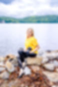 Wedding photographer sitting on a rock