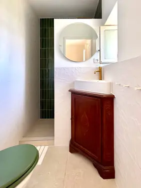 Contemporary bathroom with elegant vanity, spacious walk-in shower and upscale amenities in a renovated French country villa near the Luberon.