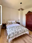 Bright luxury bedroom with modern comforts and timeless French country elegance in L'Isle-sur-la-Sorgue.