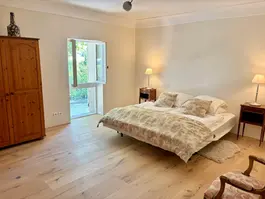 Inviting bedroom in a restored countryside villa offering elegant interiors and modern conveniences in the heart of Provence.
