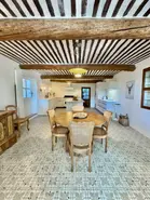 A luxury kitchen newly renovated with Italian ceramic floor tiles, a traditional ceiling, and modern kitchen appliances in the Luberon countryside of Provence.