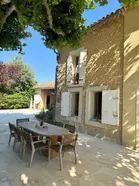 Traditional farmhouse with stone exterior features and an ancient platanus tree for tranquil time spent outdoors