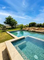 Heated luxury swimming pool and outdoor hot tub overlooking apple orchards near L'Isle-sur-la-Sorgue in the South of France.