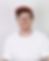 Lee, a white trans man in his thirties wearing a red cap, glasses, and white t-shirt, smiles at the camera.