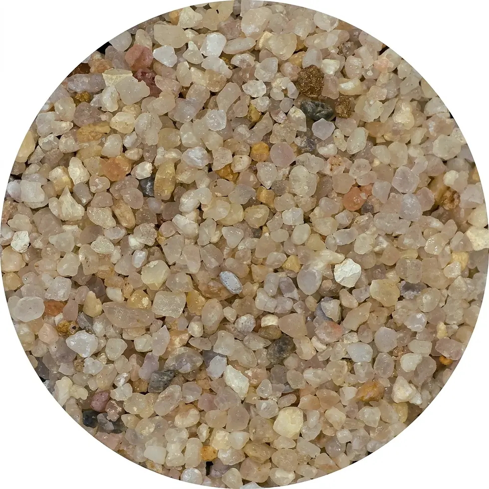 Macro photography of sand grains. The textured surface shows a variety of small, multi-colored particles.