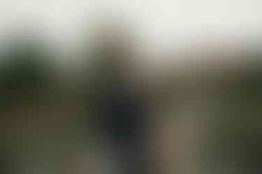 Couple embracing after a surprise proposal in Copenhagen’s King’s Garden.