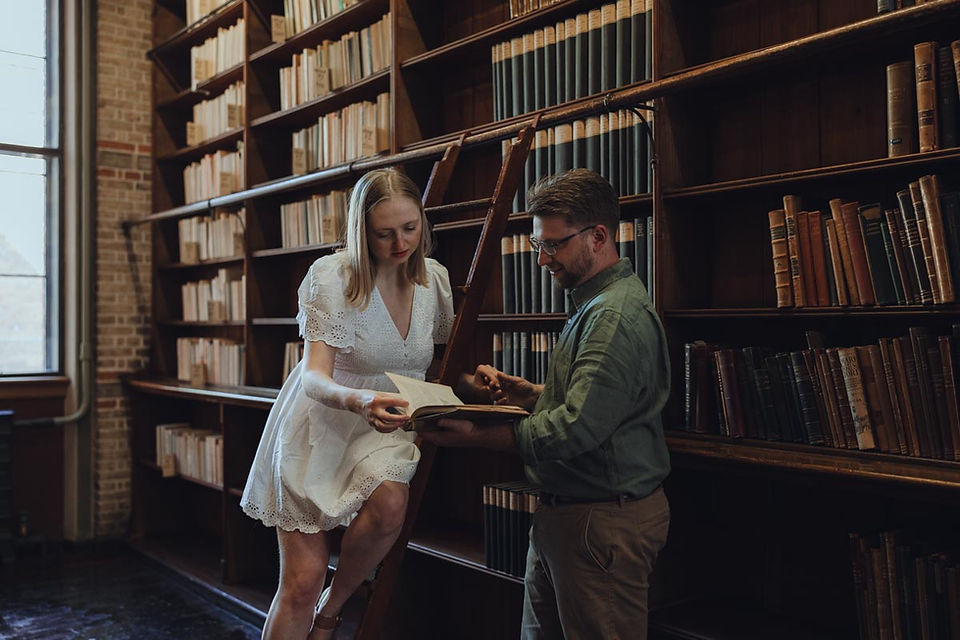 Couple reading books together in quiet public library