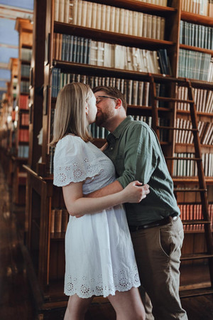 Couple sharing quiet moment among vintage books