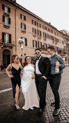 Group of friends joyfully celebrating with bride and groom in Rome