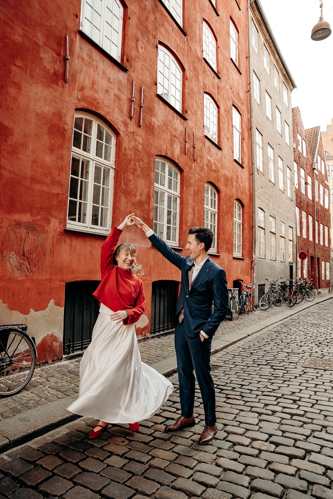 Copenhagen Elopement photo with a couple spping and being happy, enjoying the moment - very candid.