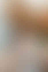 Couple sharing a kiss under a rock arch.