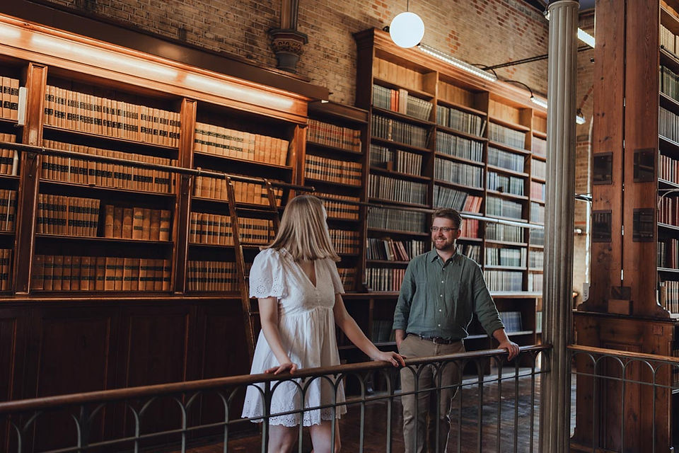 Couple lost in books during romantic photoshoot