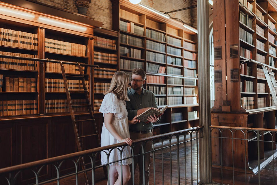 Couple lost in books during romantic photoshoot