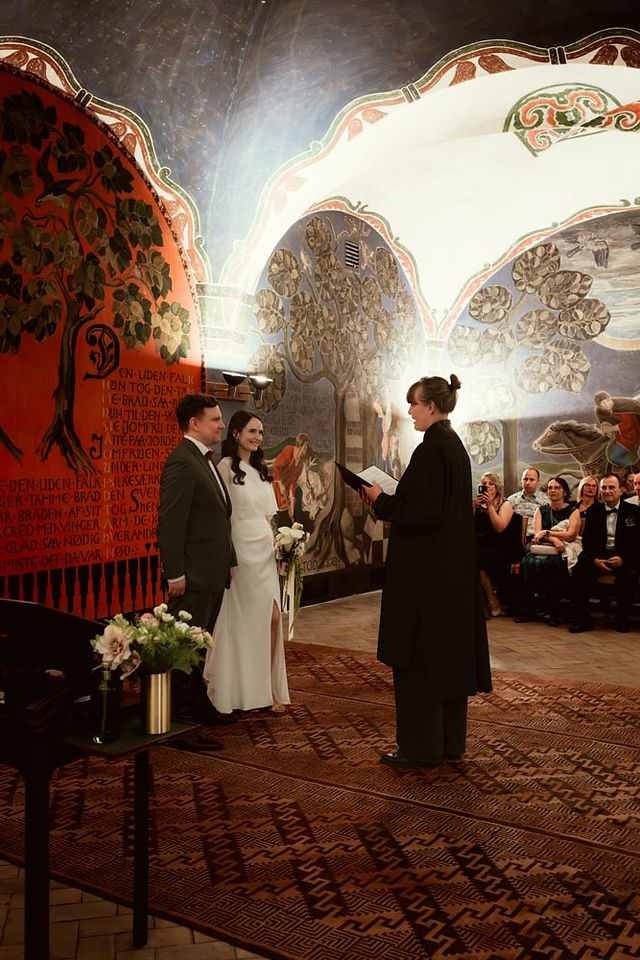 Wedding ceremony at Copenhagen City Hall with couple signing marriage documents