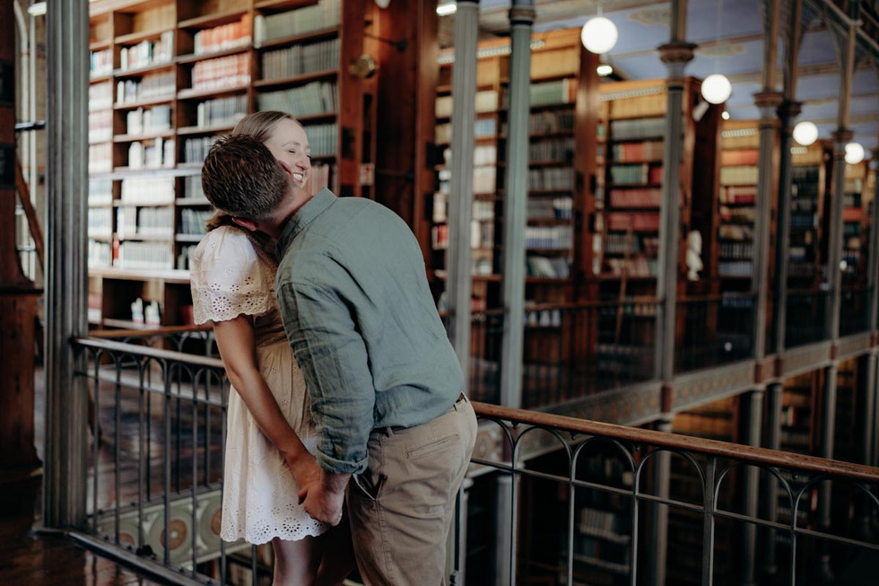 Stylish couple portrait surrounded by books
