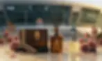 Упаковка автопарфумів та арома дифузор The Elixir стоять на фоні Донбас арени