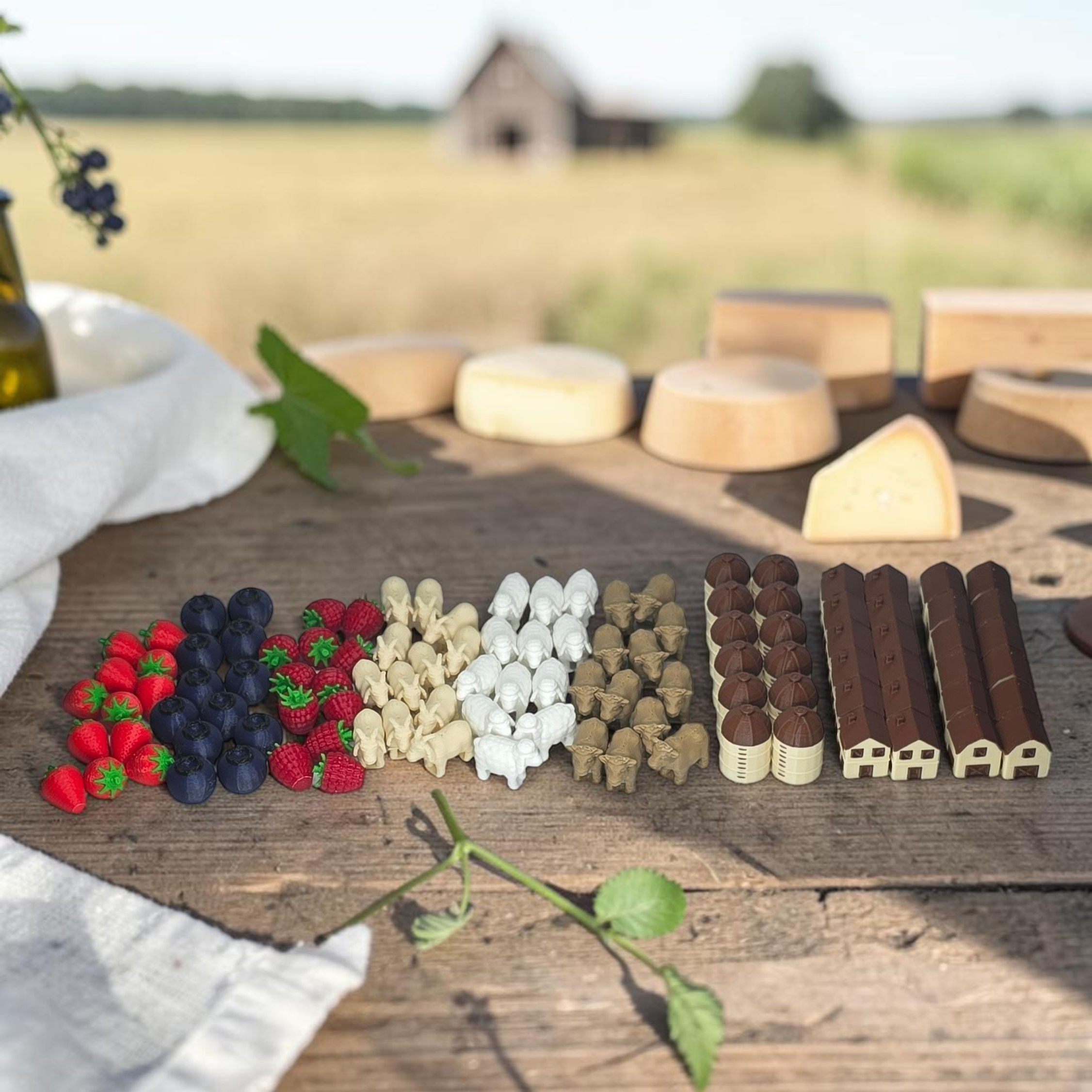 Kit de recursos 3D para Fromage com frutas, animais e construções sobre mesa rústica com cenário rural ao fundo.