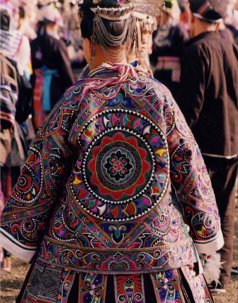Embroidered clothing worn in a village setting