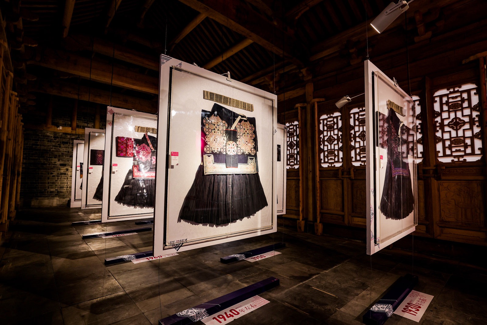 Historic garments suspended within the exhibition space