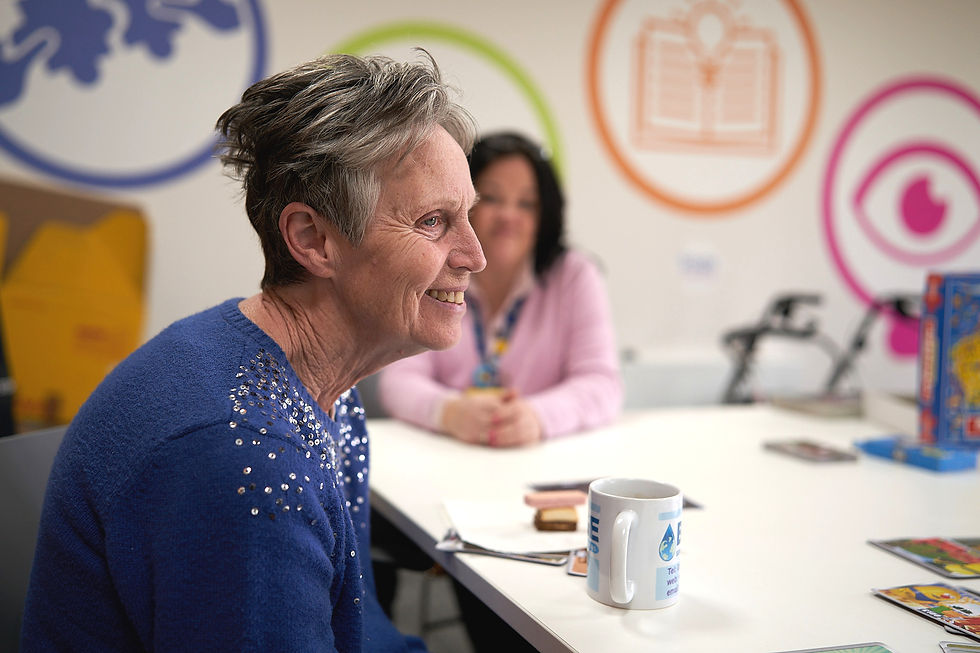 Person with dementia smiling at Sage House