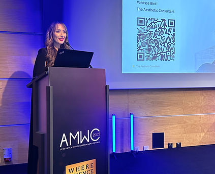 Vanessa Bird delivering her lecture on stage at AMWC in Monaco, 2025