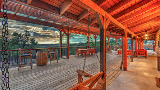 Camp-David-Retreat-Dripping-Springs-TX-lodge-deck-sitting area-sunsets-dark skies-parties