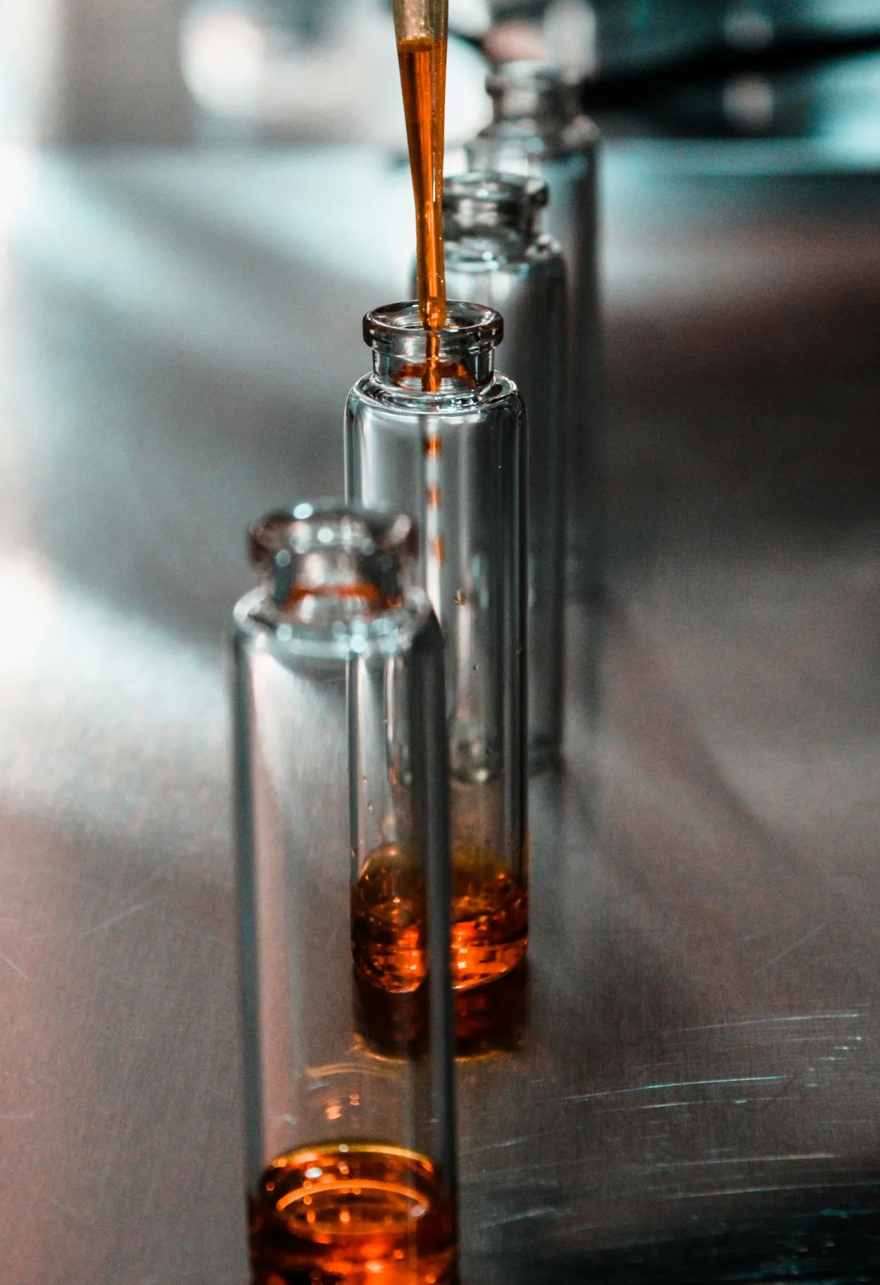 Glass vials with liquid in them being tested in a lab as part of a DNA ancestry kit given to a special someone as a unique gift idea to understand family history