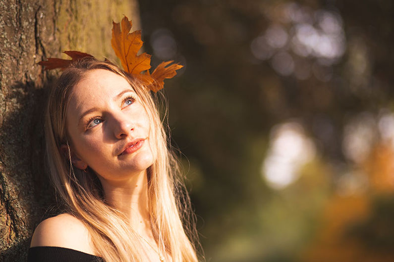 A happy girl with a leaf in her hair