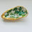 Thumbnail: Gold oyster shell with green leaf design