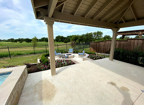Custom concrete patio with walkway to firepit designed by Tim McAuliffe