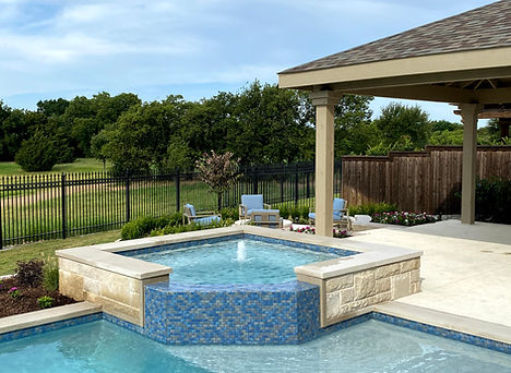 Custom spa with water feature spilling into the pool, designed by Tim McAuliffe