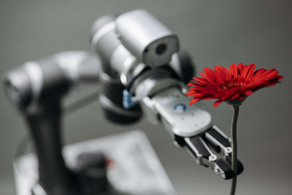A robotic arm delicately holds a vibrant red flower, symbolizing technology's harmony with nature.