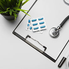 stethoscope-clipboard-and-pills-closeup-
