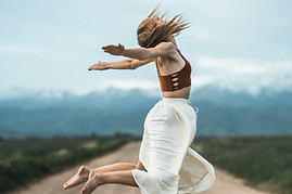 Image of a woman leaping as she steps into her conscious coaching programme