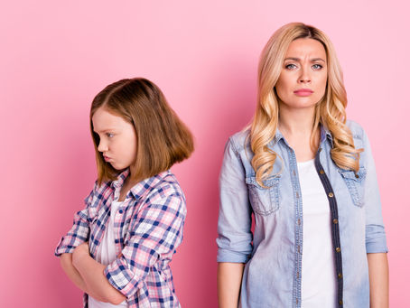 Mother and daughter in an argument with a pink background